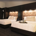 Fun City Resort Hotel Burlington guest room with two queen beds and upholstered headboards