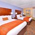 Best Western Plus Fresno Airport Hotel in Fresno: double-queen room with orange accents and desk