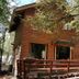 Cabañas Bordenieve in Termas de Chillan, wood cabin with wraparound deck among trees