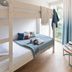 Résidence Pierre & Vacances Premium Haguna, Biarritz: bunk bed by bright window with tree view