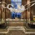 JW Marriott Hotel New Delhi Aerocity lobby with modern seating, glass partitions and hanging sculpture