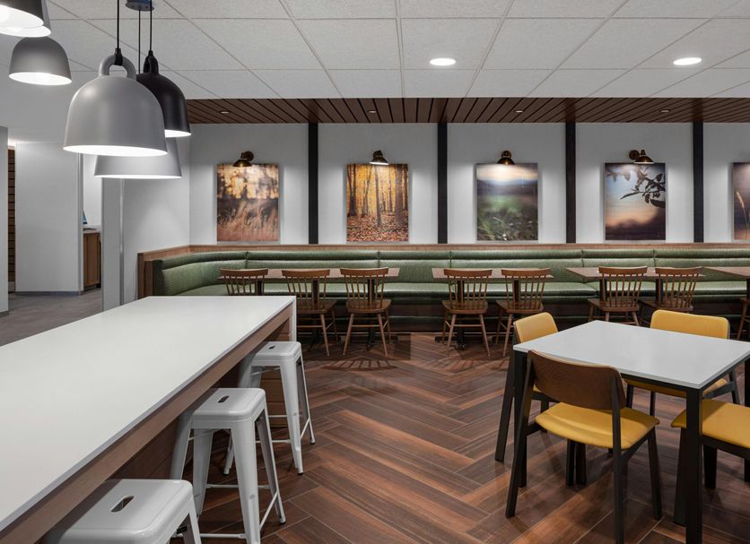 Fairfield by Marriott Inn & Suites Hailey Sun Valley breakfast area with tables, stools and wall art