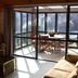 Tussock Grove Boutique in Ohakune with sunlit lounge opening to a glass-enclosed patio