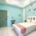 Hualien Dawan B&B in Hualien City, guest room with white bed, aqua walls, and fish wall decor