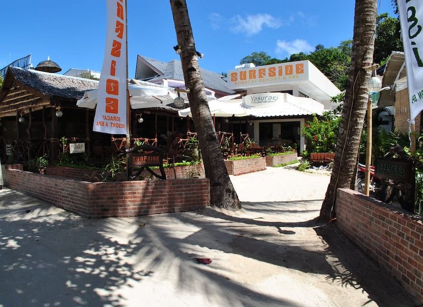 Surfside Boracay Resort in Boracay with tropical outdoor dining area and palm trees