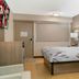 Red Roof Inn Detroit-Rochester Hills/Auburn Hills room with king bed, desk, lamps and wall art in Rochester Hills