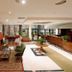 Agriani Hotel lobby in Xánthi with seating area, rug, reception desk and glass doors