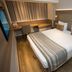 Petit Rio Hotel Rio de Janeiro room with double bed, desk, wood flooring and headboard