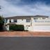 Saffron House Guesthouse in Cape Town exterior with driveway, palm tree and ocean view