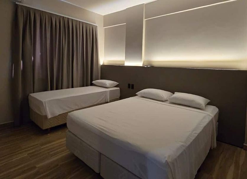 Village Iguassu Hotel room in Foz do Iguaçu with two beds and soft wall lighting