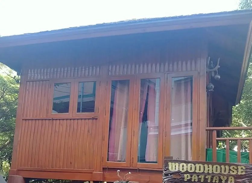 Wood House Pattaya in Pattaya, wooden elevated bungalow with balcony and stairs