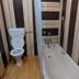 Golden Hopes Group of Houseboats, Srinagar bathroom with bathtub, toilet and striped wall paneling