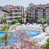 Barut B Suites in Evrenseki with large outdoor pool, white sun umbrellas and resort buildings