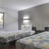 Motel 6 Little Rock, Ar - South room with two beds, wall lights, and a window in Little Rock