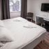 Hotel Aveny Bed & Breakfast in Gävle room with double bed, desk, chair and wall-mounted TV