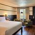High Country Motor Lodge in Flagstaff guest room with king bed, two chairs, and window seating area