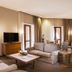 Grand Resort Jermuk in Jermuk living room suite with sofa, armchairs, TV, coffee table and balcony doors
