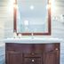 Safrano Palace in Braşov bathroom vanity with mirror, wall lights, and white sink