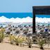 Barut B Suites in Evrenseki with beach loungers, white umbrellas, and sea views