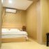 Center Of City Creo Hotel Yanbian guest room with bed, armchair and wall-mounted air conditioner