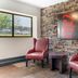 Red Roof Inn Detroit-Rochester Hills/Auburn Hills lobby seating area with stone wall and Red Roof Inn sign
