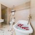 Nha Trang Prince Hotel bathroom with soaking tub, shower, marble vanity and toilet in Nha Trang