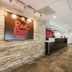 Red Roof Inn Birmingham South lobby in Birmingham with front desk and stone accent wall