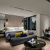 The Murray, Hong Kong, a Niccolo Hotel suite with city skyline views and seating area