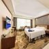 Zhangzhou Yinjia Hotel (Gucheng Branch) guest room with king bed, desk, wall TV, and open bathroom area in Zhangzhou