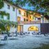 Hotel La Pergola in Lignano Sabbiadoro courtyard with outdoor dining tables and chairs
