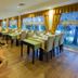 Latanya Park Resort, Bodrum dining room with set tables, large windows, and a wine cart
