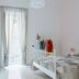 Sfumature Partenopee Naples bright guest room with balcony doors, twin beds, and white decor