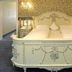 Hotel Buchenhof in Worpswede: ornate white four-poster bed in a classic guest room