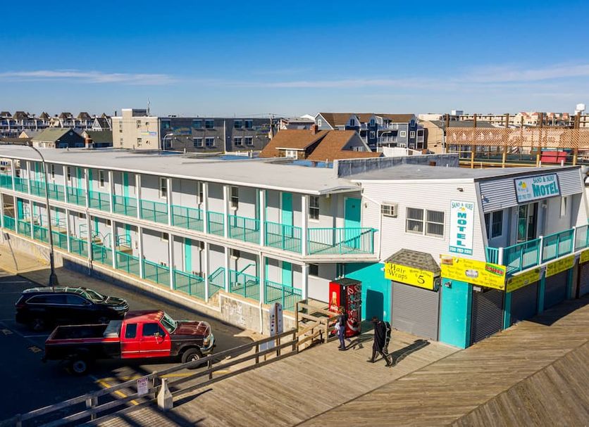 Boardwalk Sand & Surf Inn Oceanfront in Seaside Heights with oceanfront motel exterior and boardwalk entrance