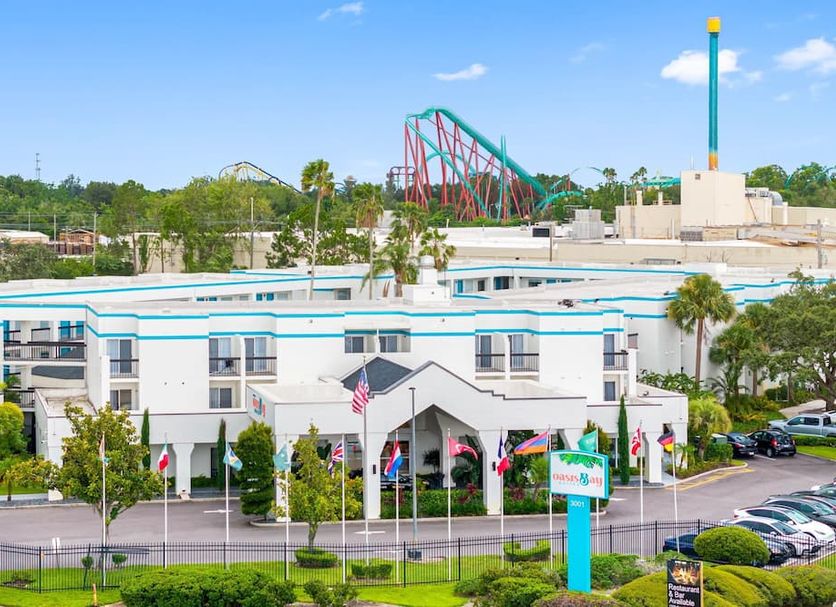 Oasis Bay Suites, Tampa exterior with Busch Gardens roller coaster visible in the background