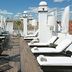 Rooftop terrace at Hospes Las Casas del Rey de Baeza in Seville with loungers, tables and city views