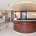 Hotel San Pancrazio lobby reception desk in Trescore Balneario with curved wood front and staircase