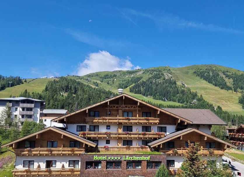 Hotel Lärchenhof in Rennweg am Katschberg with alpine mountain backdrop and chalet-style balconies