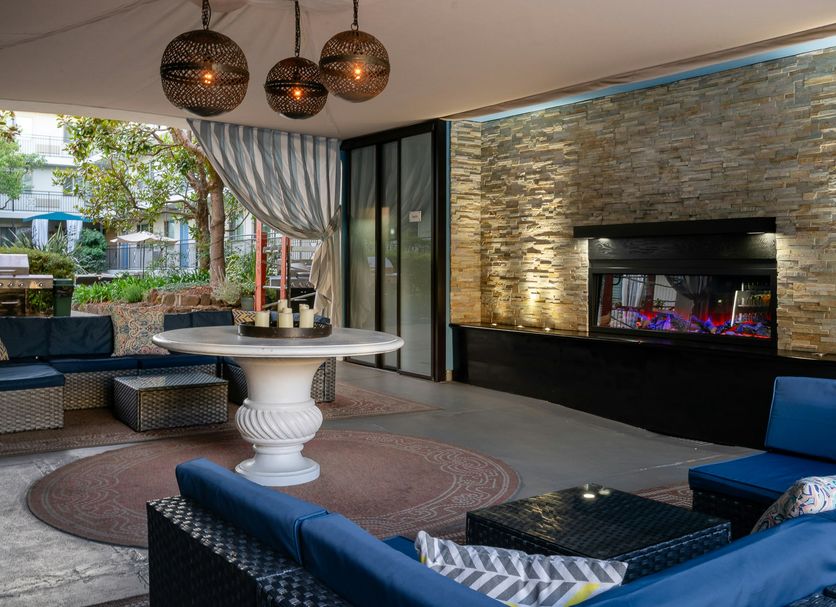 Marin Suites Hotel in Corte Madera patio lounge with fire feature, seating, and outdoor dining table