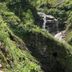 Hotel Lindenhof in Bad Gastein with a scenic waterfall and lush green mountain gorge view