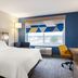 Holiday Inn Express & Suites Cincinnati Se Newport By IHG room with king bed, window seat and city view in Bellevue