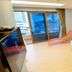 Marianne Hotel Busan guest room with two beds, ocean-view balcony, and orange lounge chair