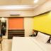 Hotel Golden Treat, Indore: modern guest room with double bed, desk, TV, and orange window shade