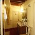 Cà Furlan Venice hallway with wooden beams, red carpet, sideboard, and cream doors