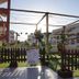 Ukino Palmeiras Village in Porches: outdoor adventure play area with ropes, fence and sunlit resort buildings