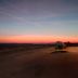 Auberge de la Baie in Pontorson with a sunset sky over a quiet road and open landscape