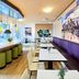 B&B Hotel Frankfurt City-Ost lounge with counter seating, tables, purple banquette and city mural
