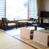 Kameya Ean in Izu guest room with tatami mats, low table, floor cushions, and chairs by the window
