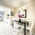 Hollywood by the Sea in Hollywood: bright kitchen and dining area with white tile floors and black table