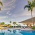 Fiesta Americana Cozumel pool with palm trees and ocean view in Cozumel